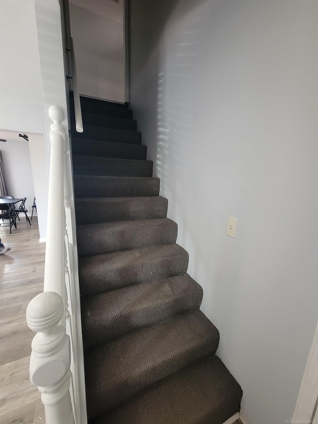 stairway with wood finished floors
