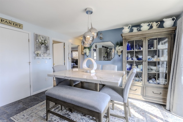dining room with stone tile floors