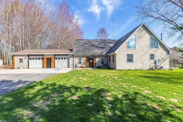 view of front of house with driveway and a front lawn