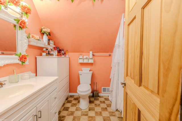 full bathroom featuring vanity, toilet, tile patterned floors, lofted ceiling, and visible vents
