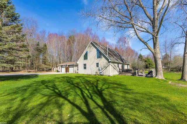 view of property exterior with a garage, a deck, a chimney, a lawn, and driveway