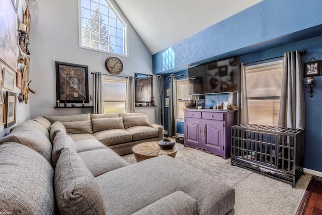 living room featuring carpet floors and high vaulted ceiling