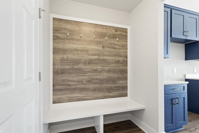 mudroom with baseboards and wood finished floors