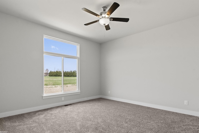 carpeted empty room with plenty of natural light, baseboards, and ceiling fan