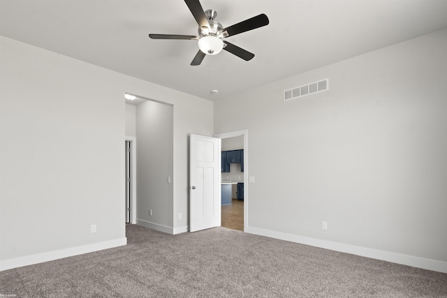 unfurnished bedroom with baseboards, ceiling fan, carpet, and visible vents