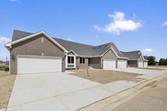 single story home featuring an attached garage, roof with shingles, driveway, and brick siding