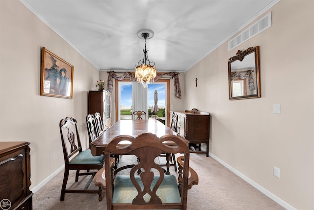 dining room featuring crown molding, visible vents, a chandelier, and light colored carpet