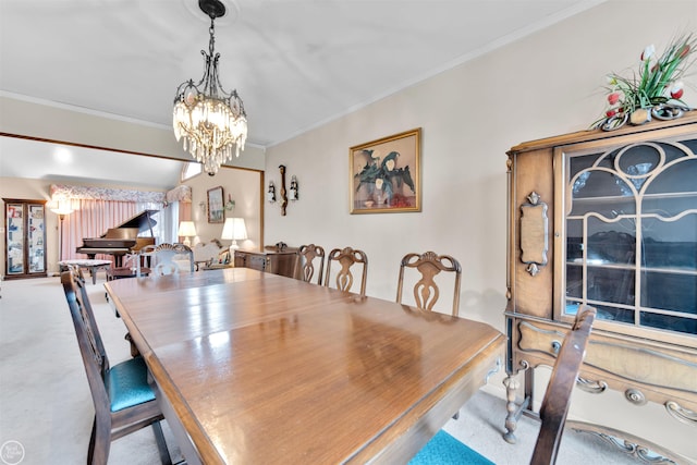 carpeted dining area with crown molding and a chandelier