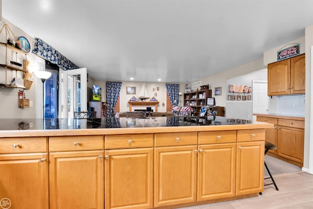 kitchen with recessed lighting, open floor plan, and light wood-type flooring