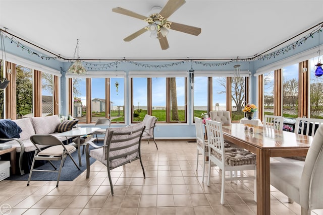 sunroom / solarium with baseboards and tile patterned flooring