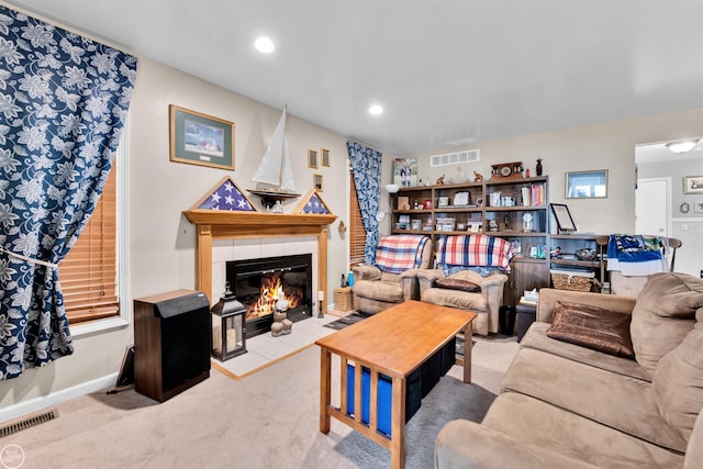 carpeted living room featuring recessed lighting, baseboards, visible vents, and a tile fireplace