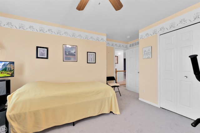 bedroom with a closet, carpet floors, baseboards, and a ceiling fan