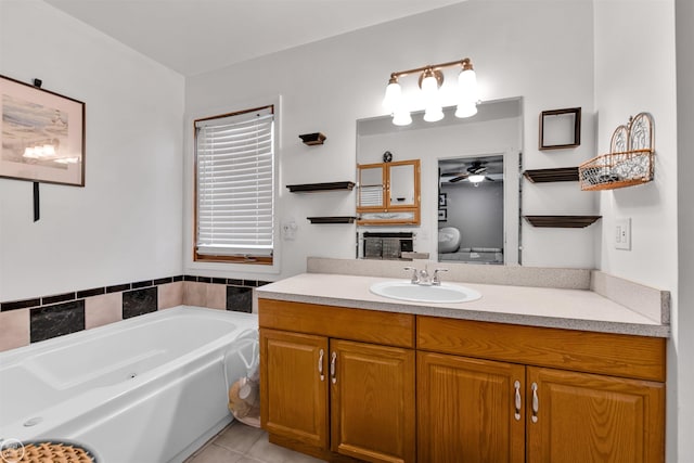 bathroom featuring ceiling fan, a garden tub, tile patterned flooring, vanity, and toilet