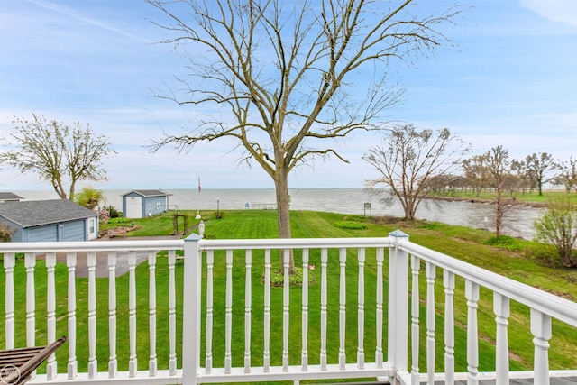 view of yard featuring a water view and an outbuilding