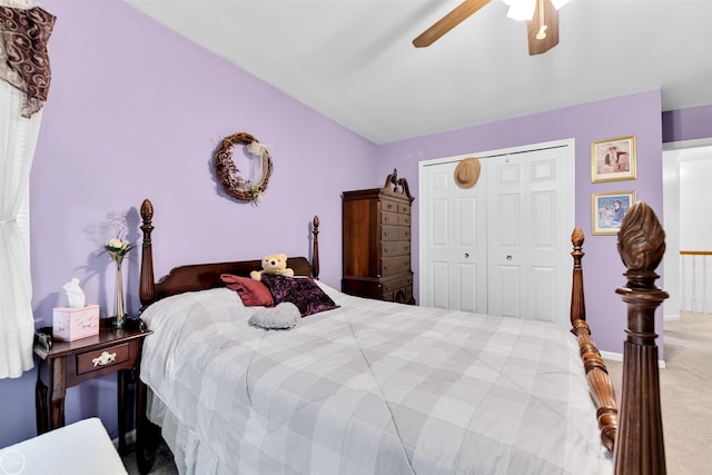 carpeted bedroom featuring a ceiling fan, a closet, and lofted ceiling
