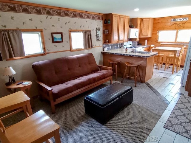 living area with recessed lighting and wallpapered walls