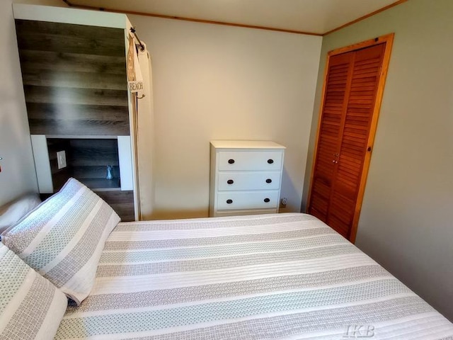 bedroom with a closet and ornamental molding