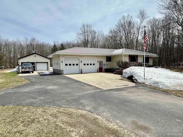 ranch-style home with an attached garage and metal roof