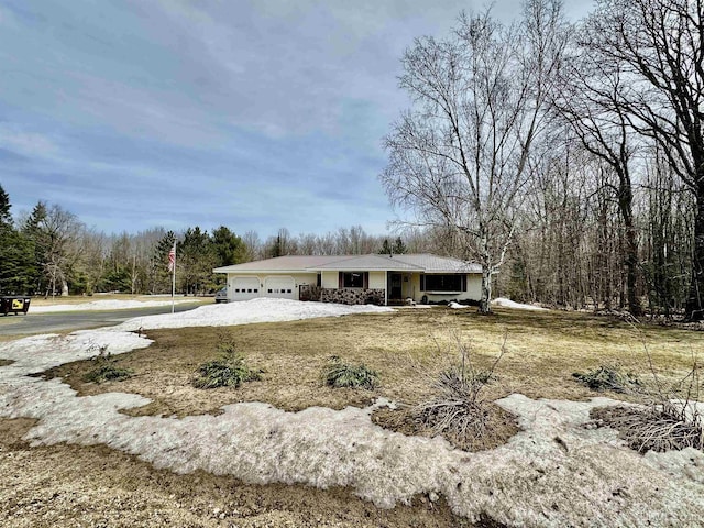view of front of home featuring a view of trees and a garage