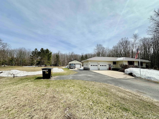 exterior space featuring a lawn, driveway, and a garage