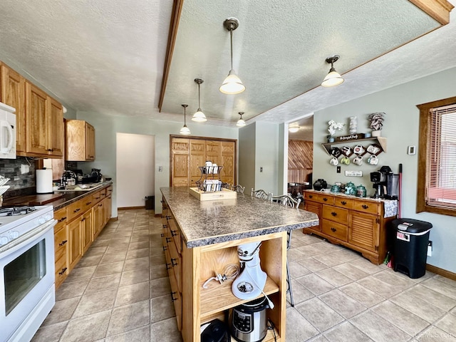 kitchen featuring white appliances, a textured ceiling, open shelves, and dark countertops