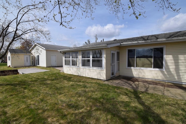 exterior space featuring an outbuilding, a patio area, and a front lawn