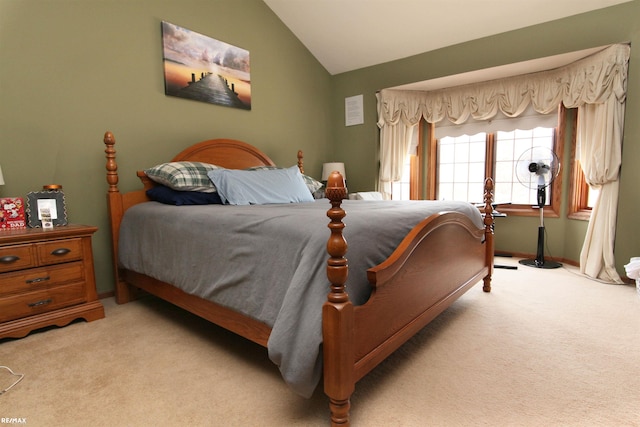 bedroom with carpet flooring and lofted ceiling