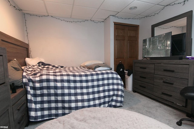 bedroom featuring a closet, carpet flooring, and a paneled ceiling