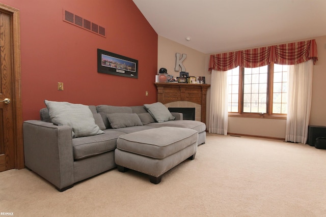 carpeted living area featuring visible vents, lofted ceiling, and a fireplace