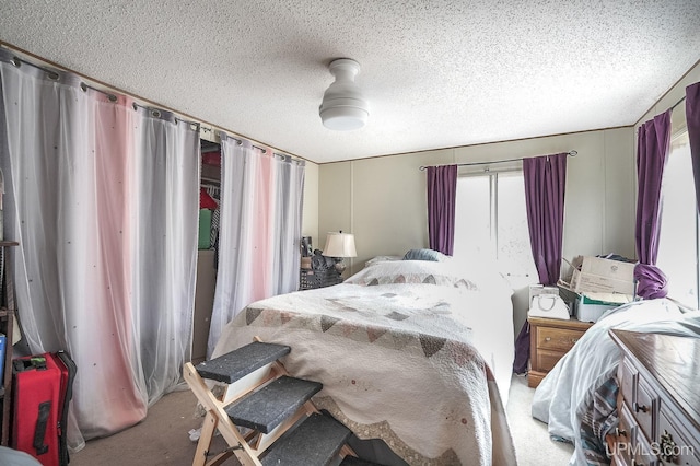 carpeted bedroom with a textured ceiling