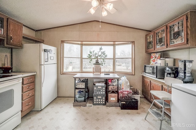 kitchen with white appliances, light countertops, a ceiling fan, lofted ceiling, and light floors