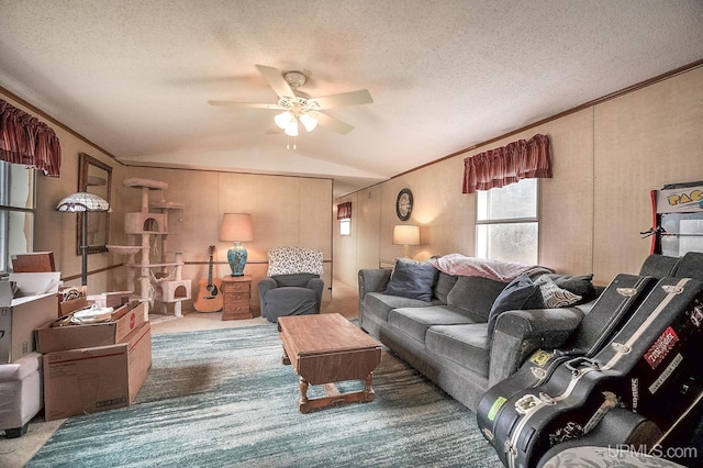 carpeted living area featuring crown molding, ceiling fan, a textured ceiling, and lofted ceiling