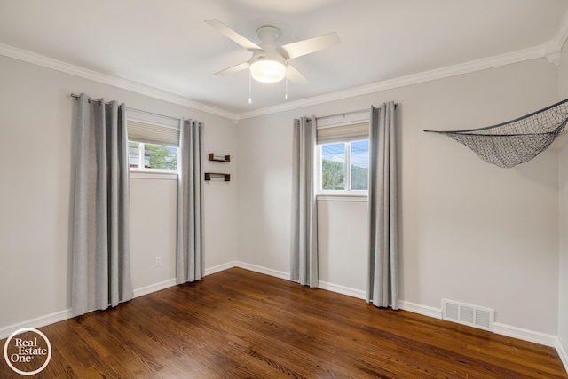 unfurnished room with a ceiling fan, visible vents, ornamental molding, and dark wood finished floors