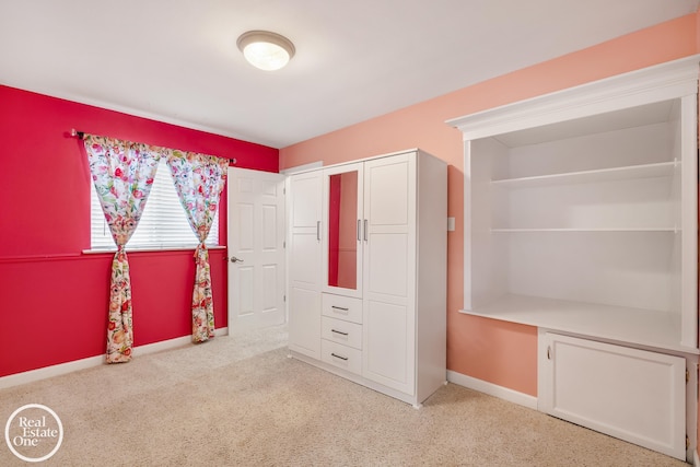 unfurnished bedroom with a closet, baseboards, and carpet flooring
