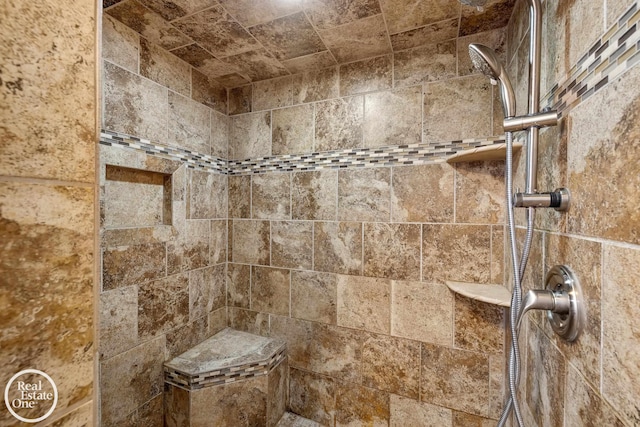 bathroom with a tile shower
