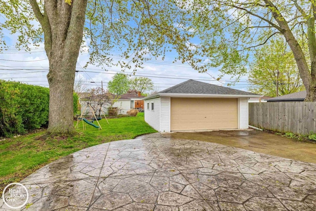 detached garage featuring fence