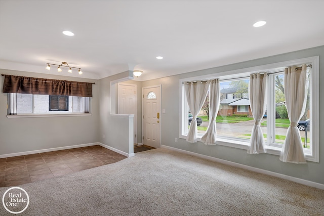 interior space featuring baseboards, plenty of natural light, carpet, and recessed lighting