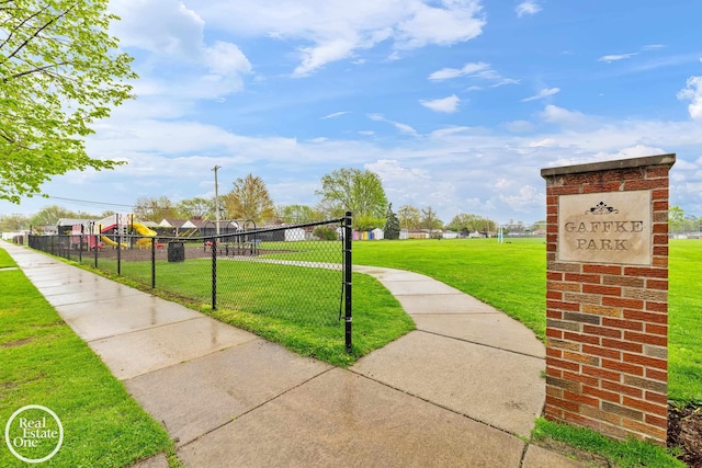 surrounding community featuring fence and a yard