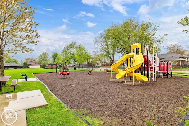 community playground featuring a lawn and fence