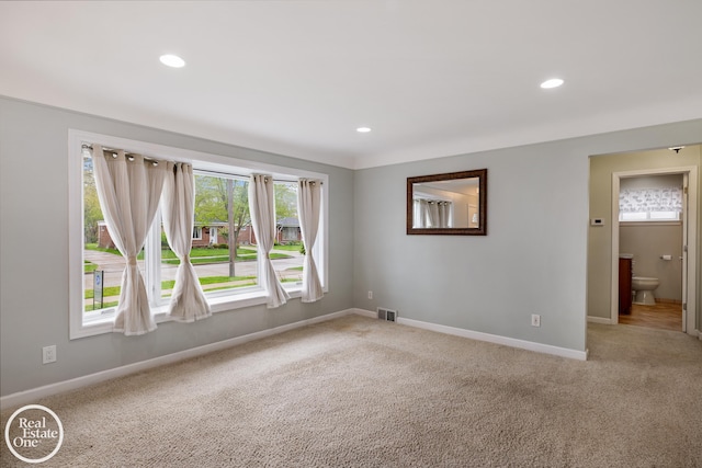 spare room featuring visible vents, recessed lighting, baseboards, and light carpet