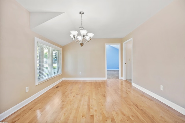 unfurnished dining area featuring baseboards, a chandelier, vaulted ceiling, and light wood finished floors