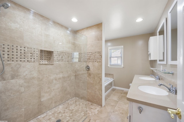 bathroom with walk in shower, a sink, double vanity, baseboards, and a bath