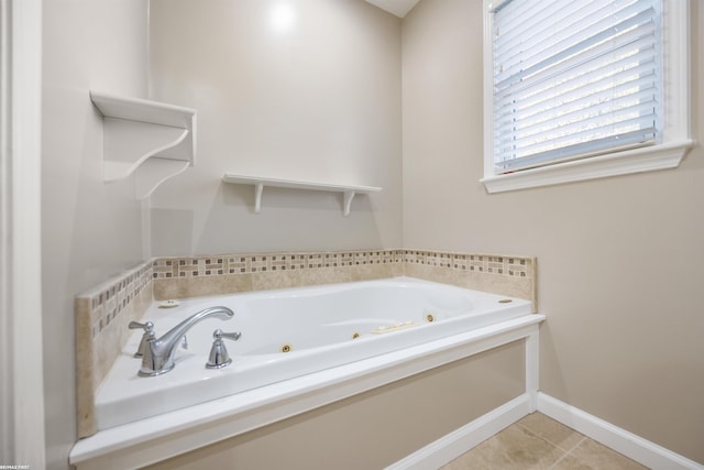 full bath with a tub with jets, baseboards, and tile patterned floors