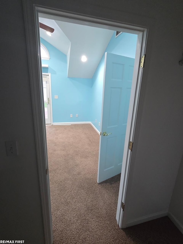 additional living space with carpet floors, baseboards, and vaulted ceiling