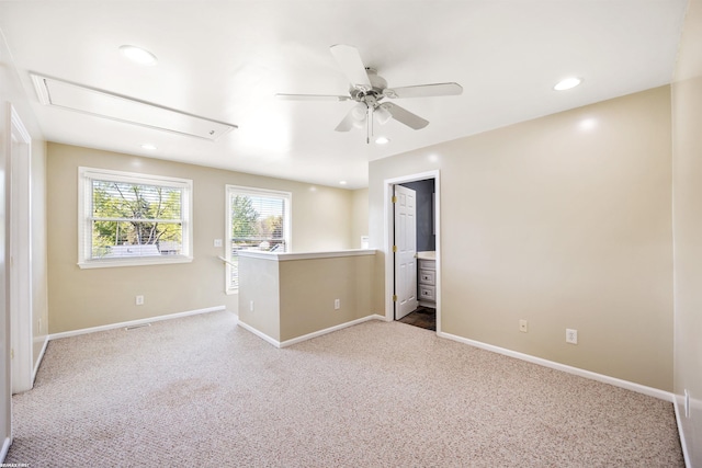 carpeted spare room featuring ceiling fan, attic access, visible vents, baseboards, and recessed lighting