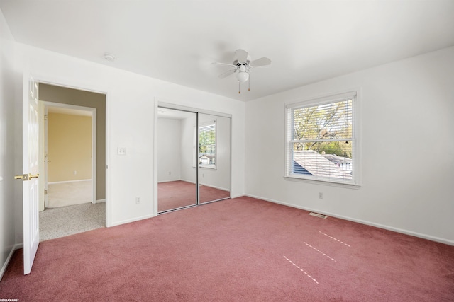unfurnished bedroom with carpet floors, a ceiling fan, baseboards, and a closet