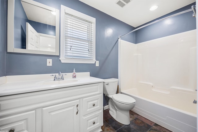 full bathroom with stone finish floor, shower / bathing tub combination, visible vents, vanity, and toilet