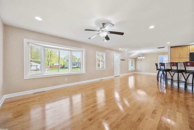 unfurnished living room featuring recessed lighting, light wood-style floors, baseboards, and visible vents