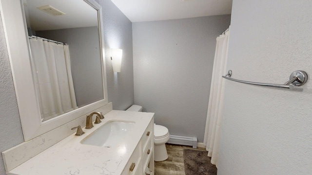 full bathroom with visible vents, vanity, a baseboard radiator, toilet, and a textured wall