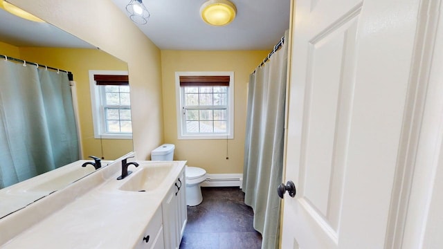 full bathroom with vanity, baseboard heating, and toilet